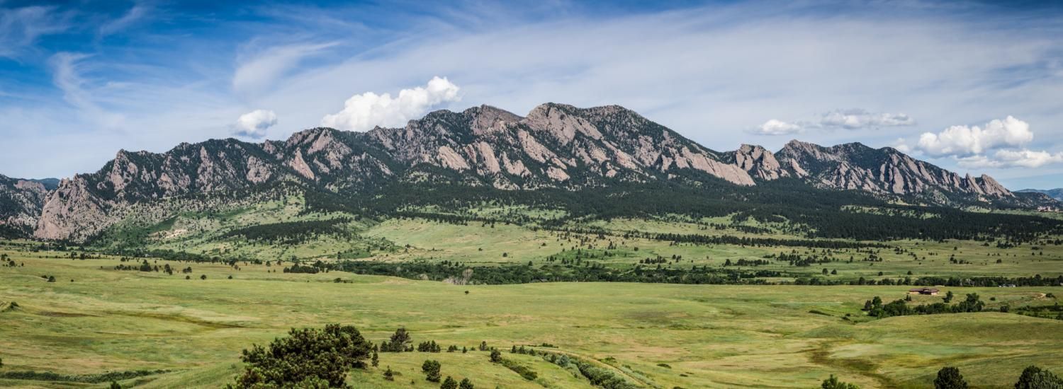 The expansive Flatirons undulate across the valley