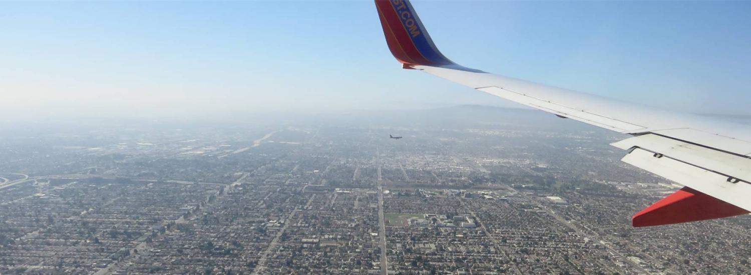Two airliners fly over densely populated Los Angeles as smog blurs the horizon in this 2015 photo