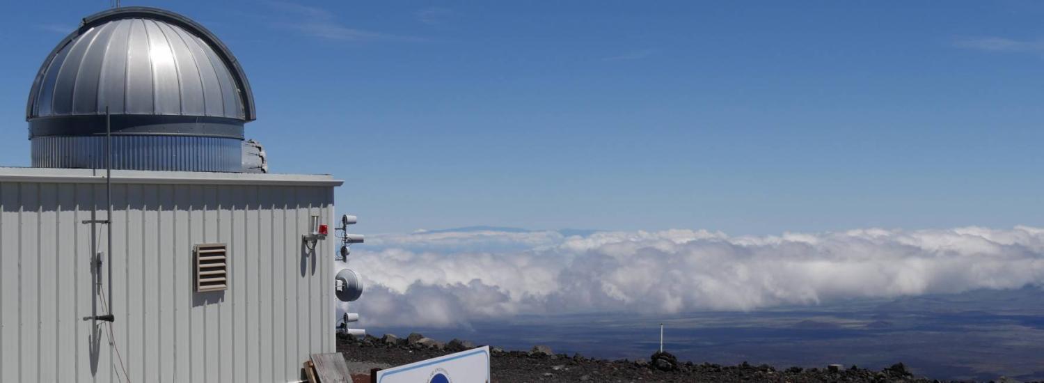 Photo of NOAA&#039;s Mauna Loa observatory on the barren slopes of a volcano in Hawaii. 
