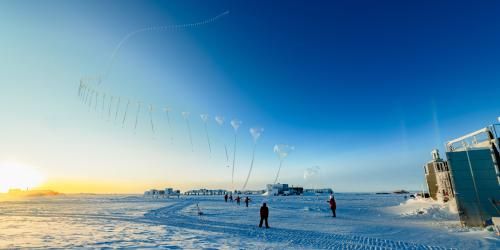 A timelapse photo of a weather balloon being released in a snowy landscape. 