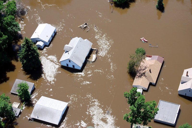 Aerial view of homes being flooded by brown water