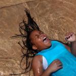 Trelynn Watkins, 10, laughs as she plays in the Julia Primrose Fountain.
