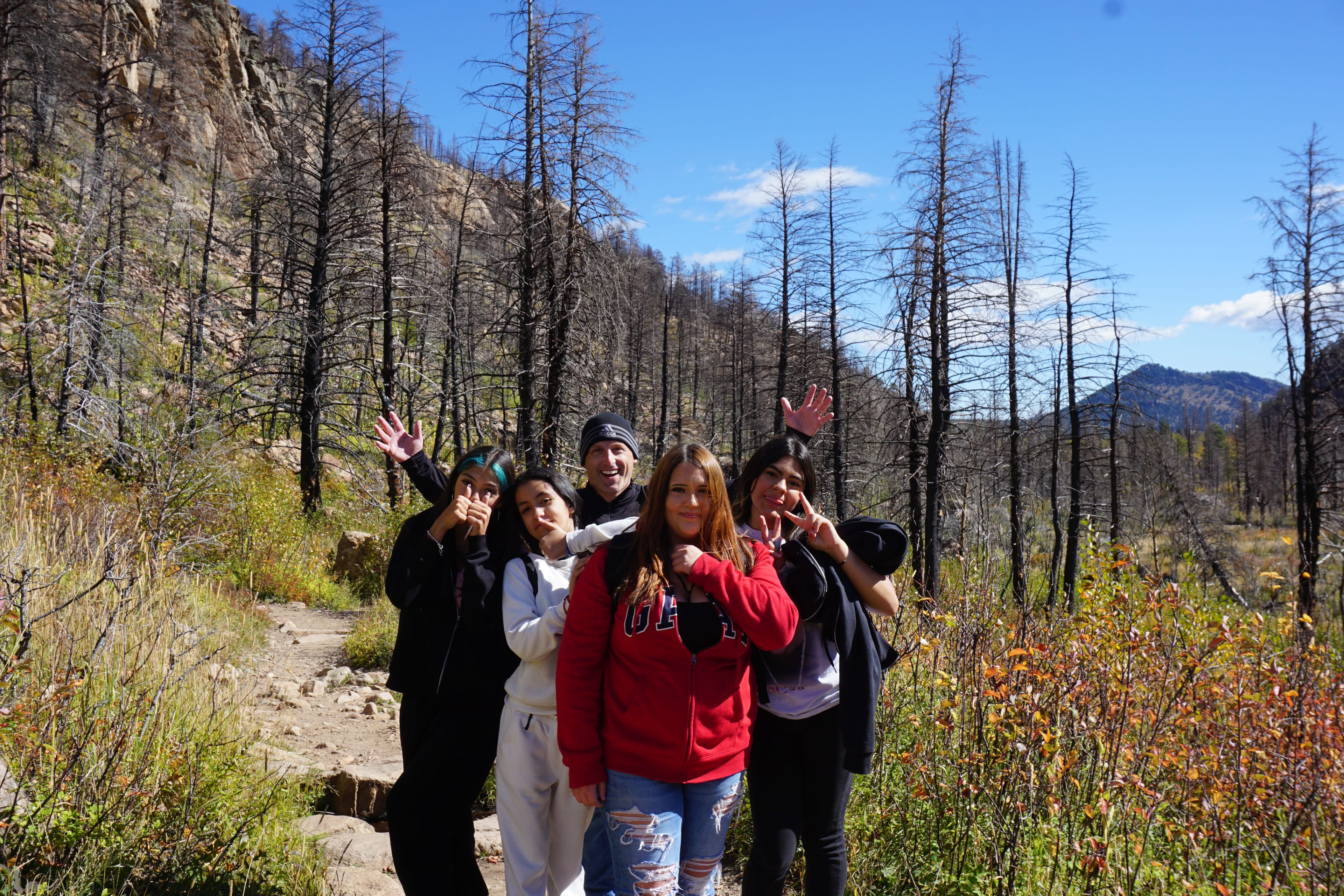 STEM Launcyh students walk along a trail and pose for a photo