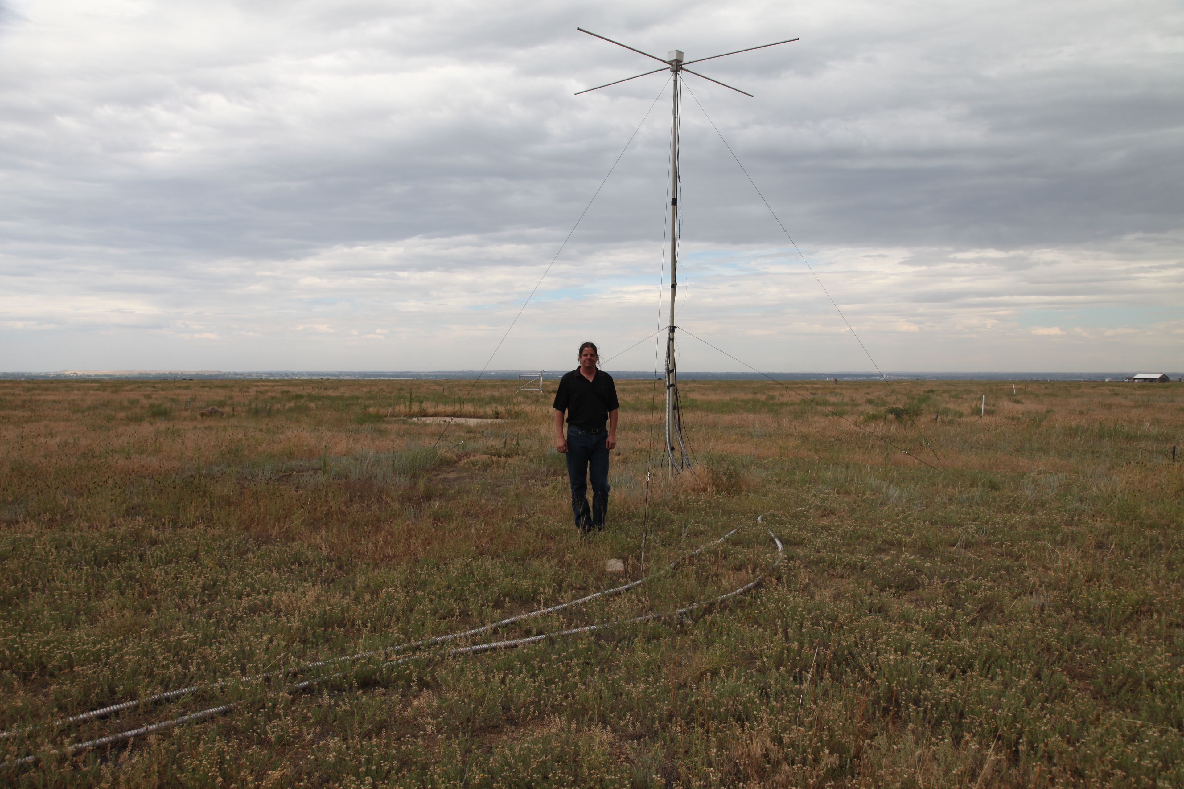 Researcher Justin Mabie stands in front of a test tower.