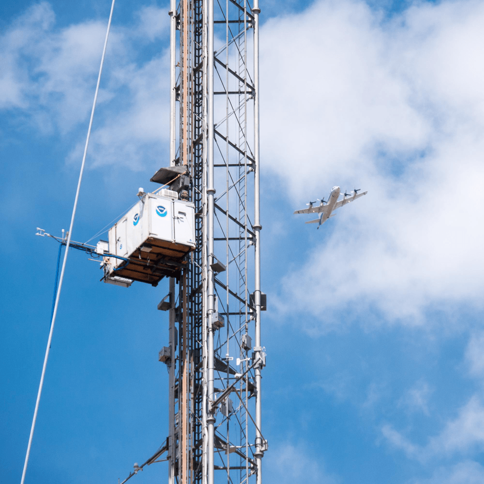 Instrumented NASA P-3 aircraft flies by the Boulder Atmospheric Observatory during a field campaign in summer 2014.