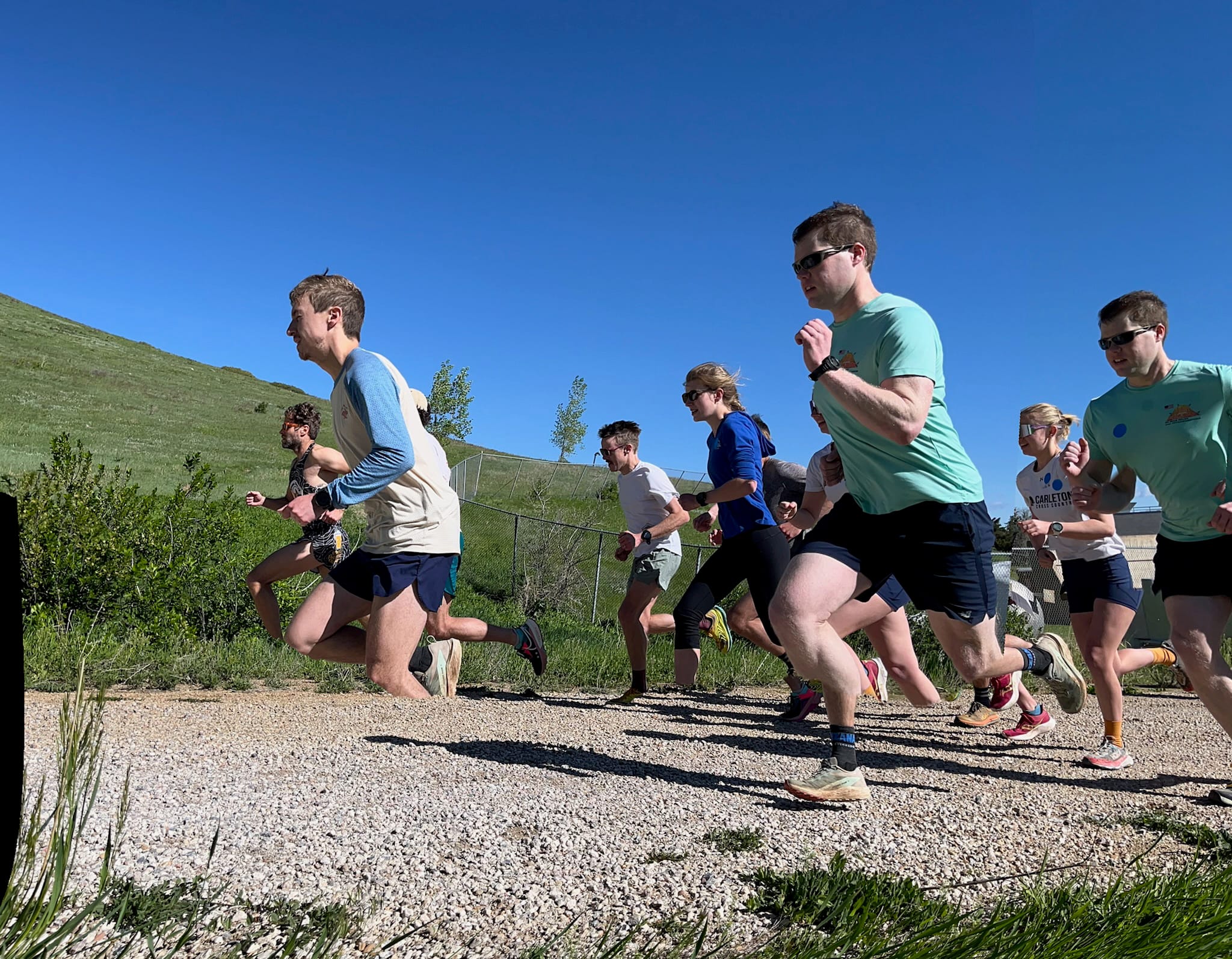 A group of people running up a trail