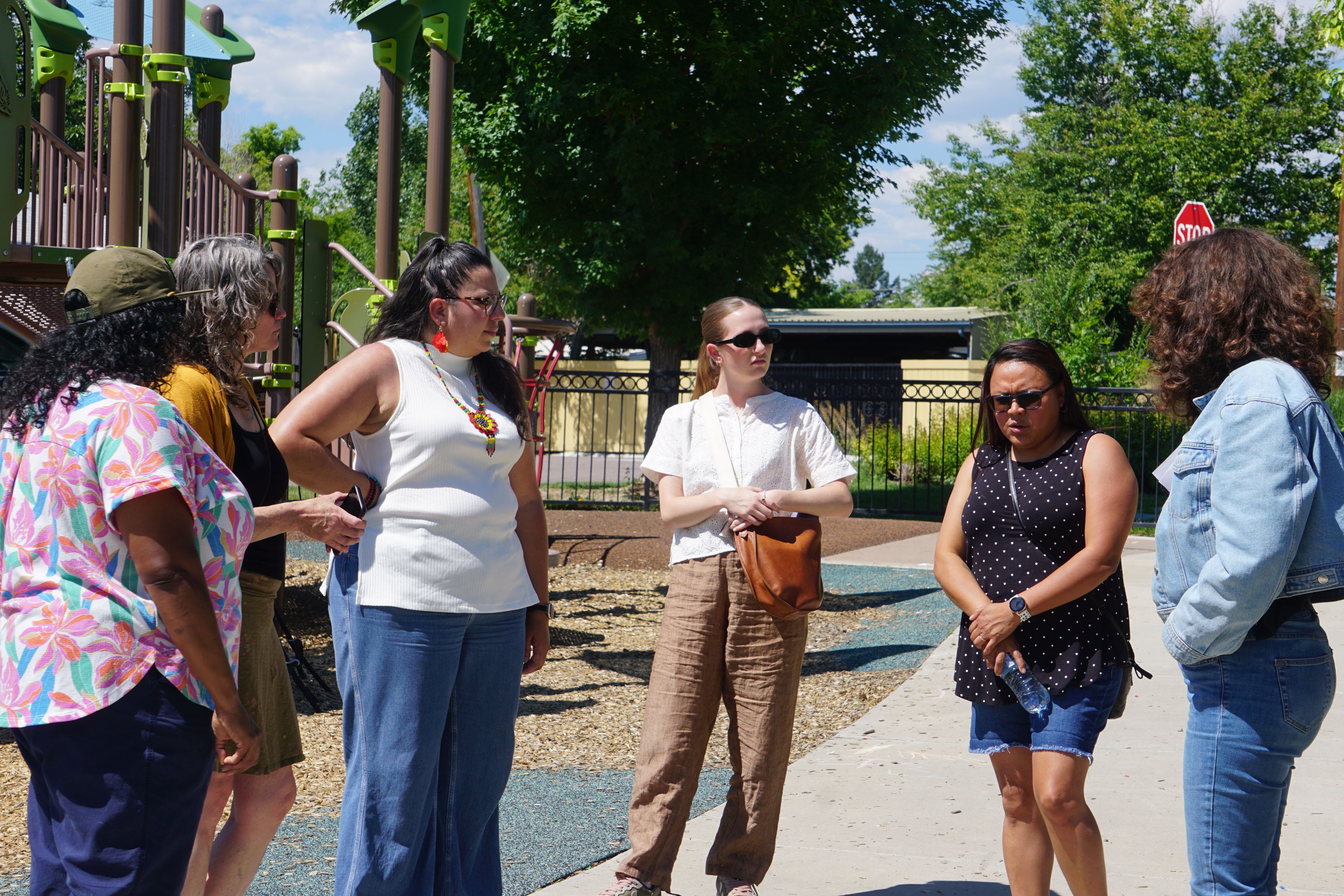 Members of the design team stand together in a Denver park