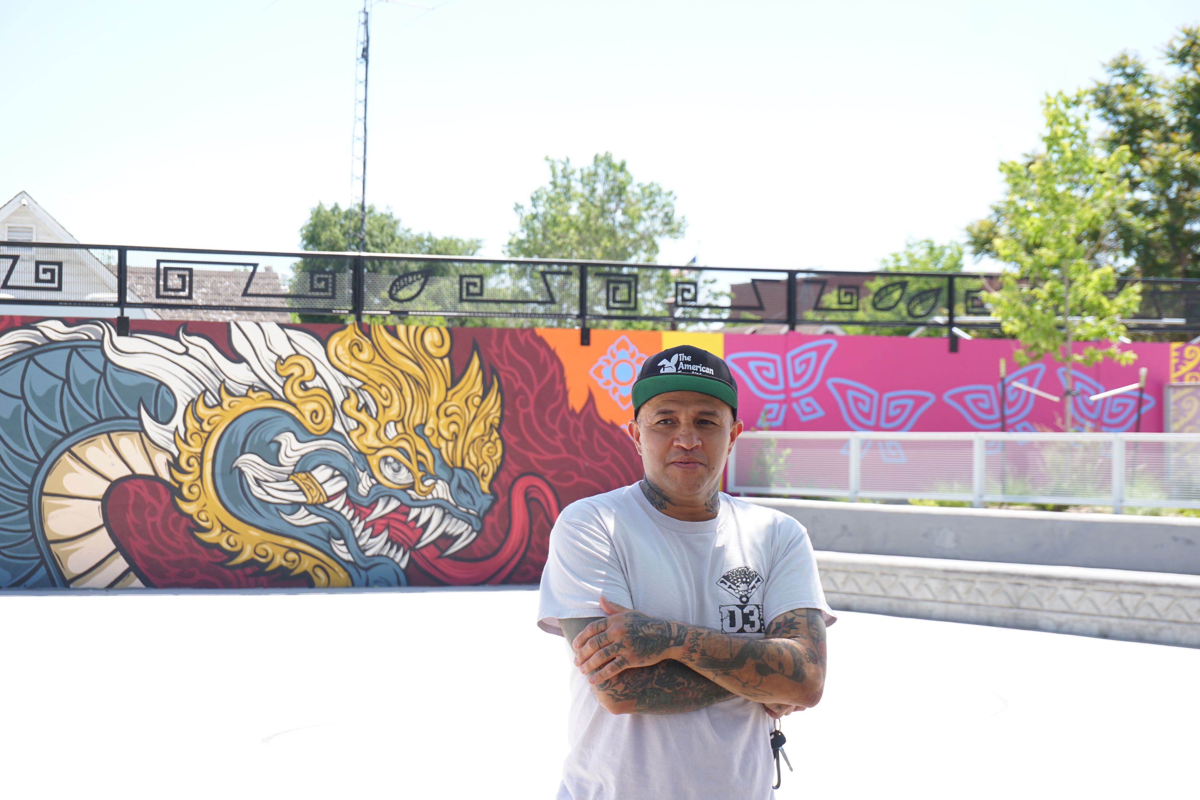 Santi Jarmillo, the Denver artist and advocate stands in front of his art