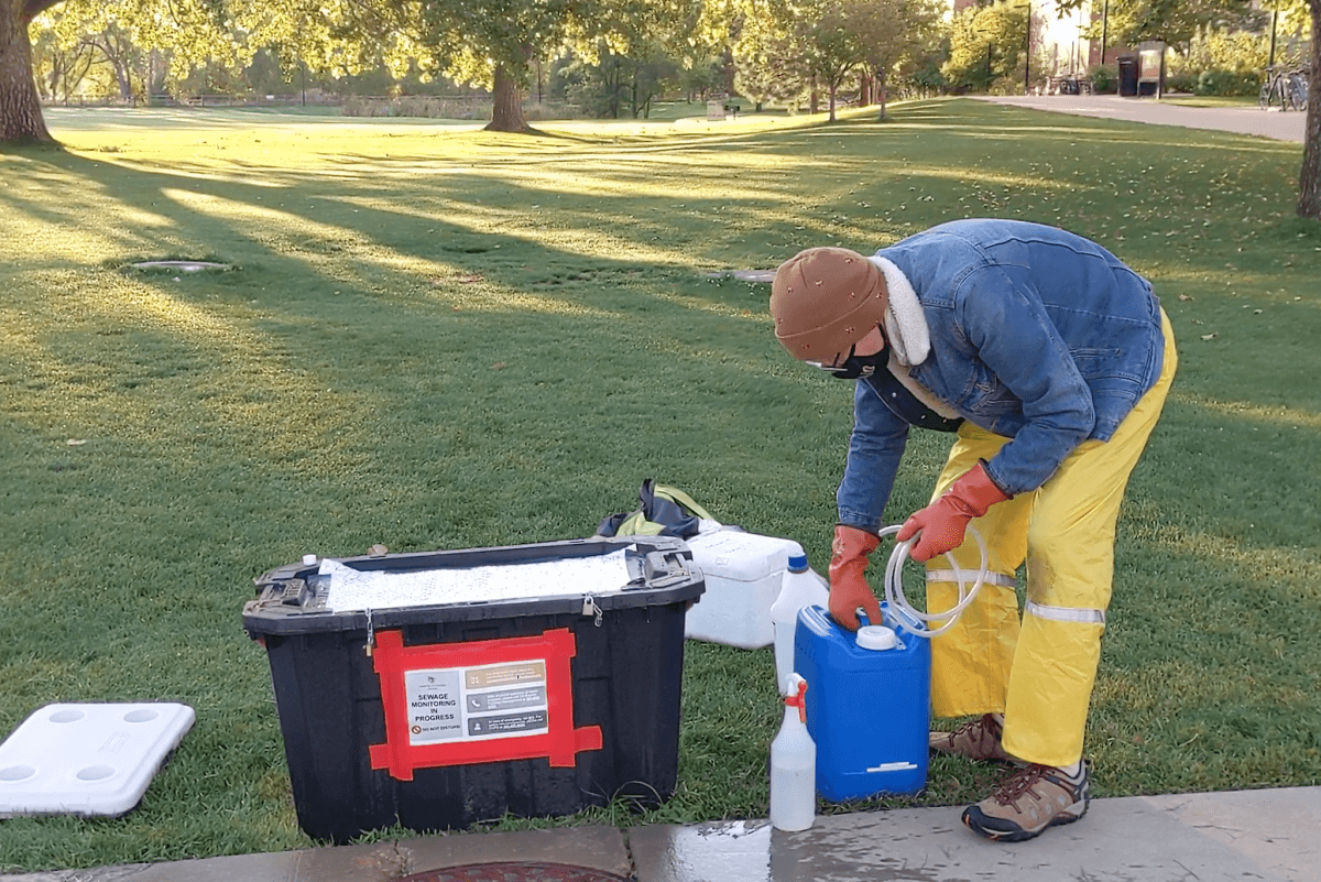 CRESTEN MANSFEDLT, CU ENVIRONMENTAL ENGINEERING, COLLECTS SEWAGE SAMPLES DURING THE FALL 2020 SEMESTER