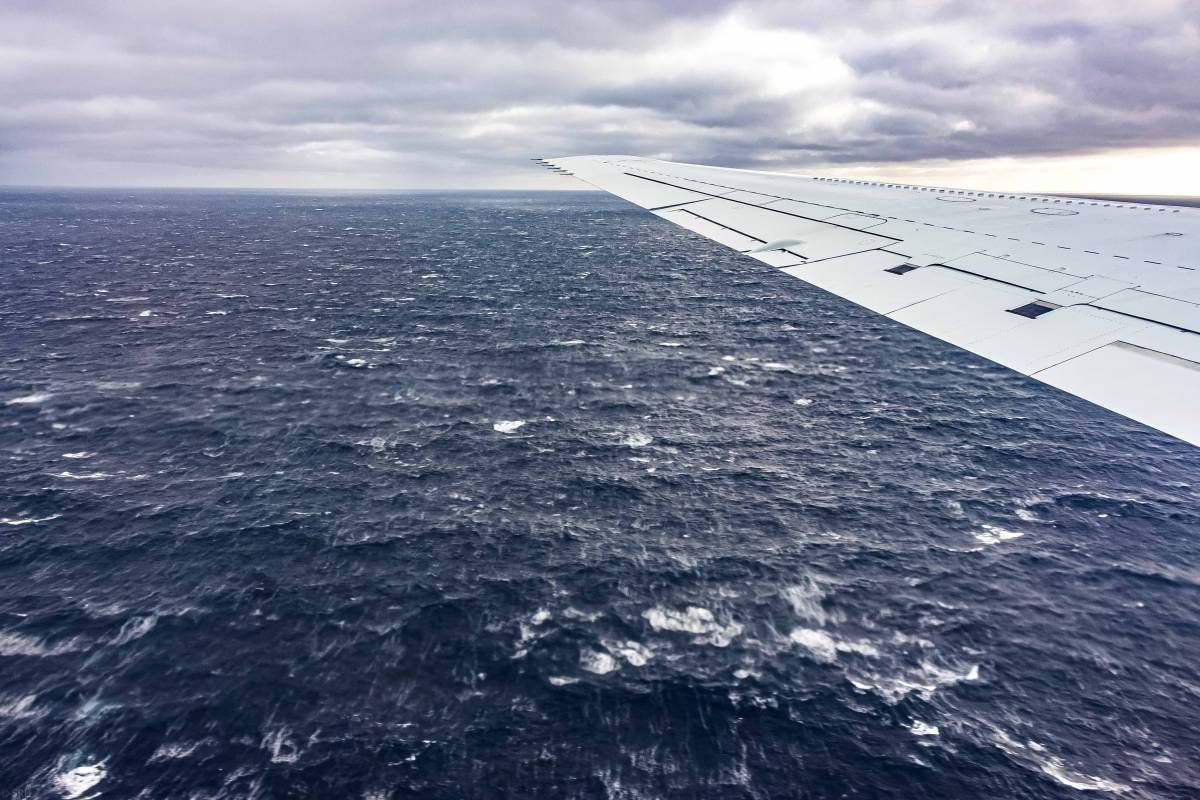 Shot of ocean from plane window.
