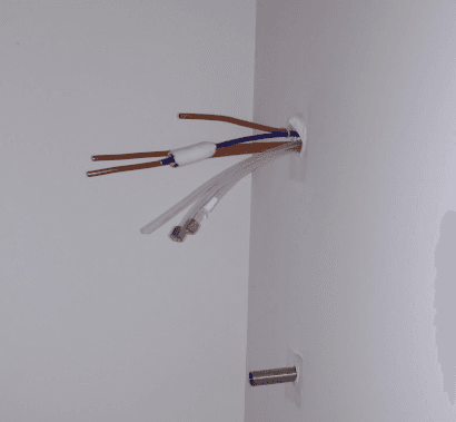 Wires peak out of a corner of the wall