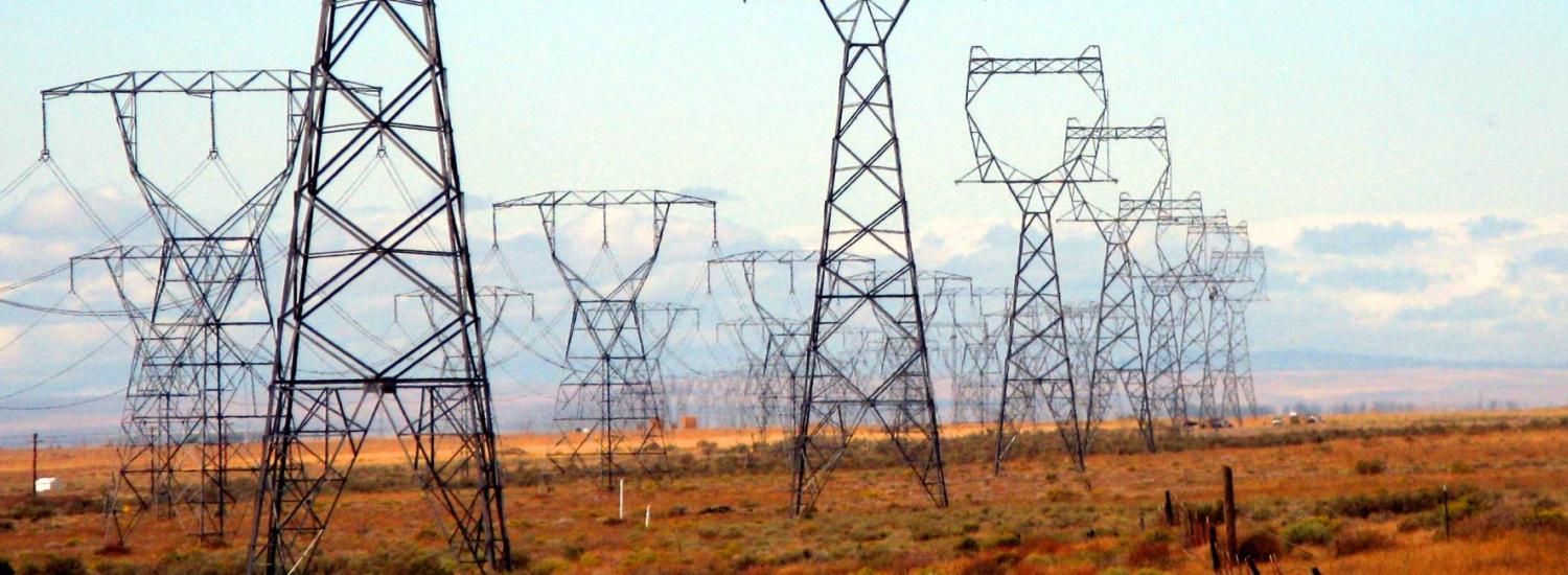 Powerlines in a flat, desert landscape