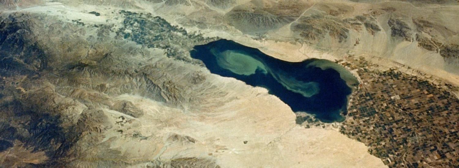 Green blue and dusty image of a drying lake seen by air.