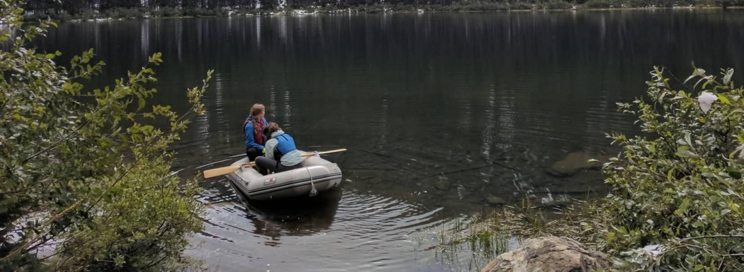 Lead author Kyra Clark-Wolf balances on a raft while collecting samples in Silver Lake, Montana