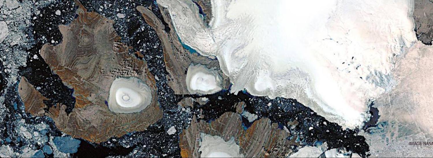 Landsat image of ice caps in northern Savernaya Zemlya, Russian Arctic Islands (80 degrees N.). The scene shows zones of melting on the ice caps. The largest ice cap is about 80 km across. Image courtesy of Julian Dowdeswell, Scott Polar Research Institute, Cambridge, UK.