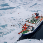 Seen from the air the Polarstern floats alongside the MOSAiC ice floe
