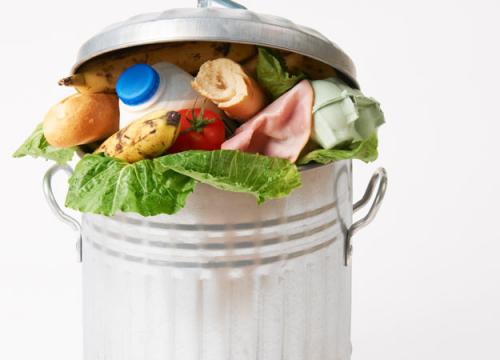 A trash can overflowing with food.