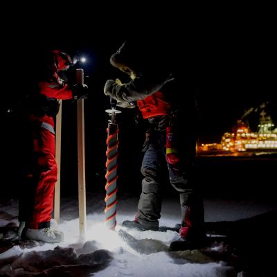 A scientist drills an ice core.