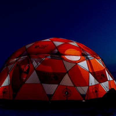 A tent glowing from within.