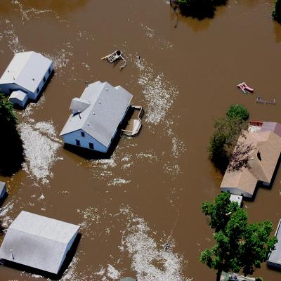 Aerial view of homes being flooded by brown water